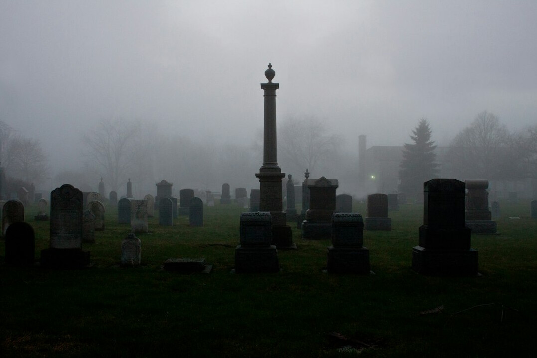 creepy misty graveyard at dusk